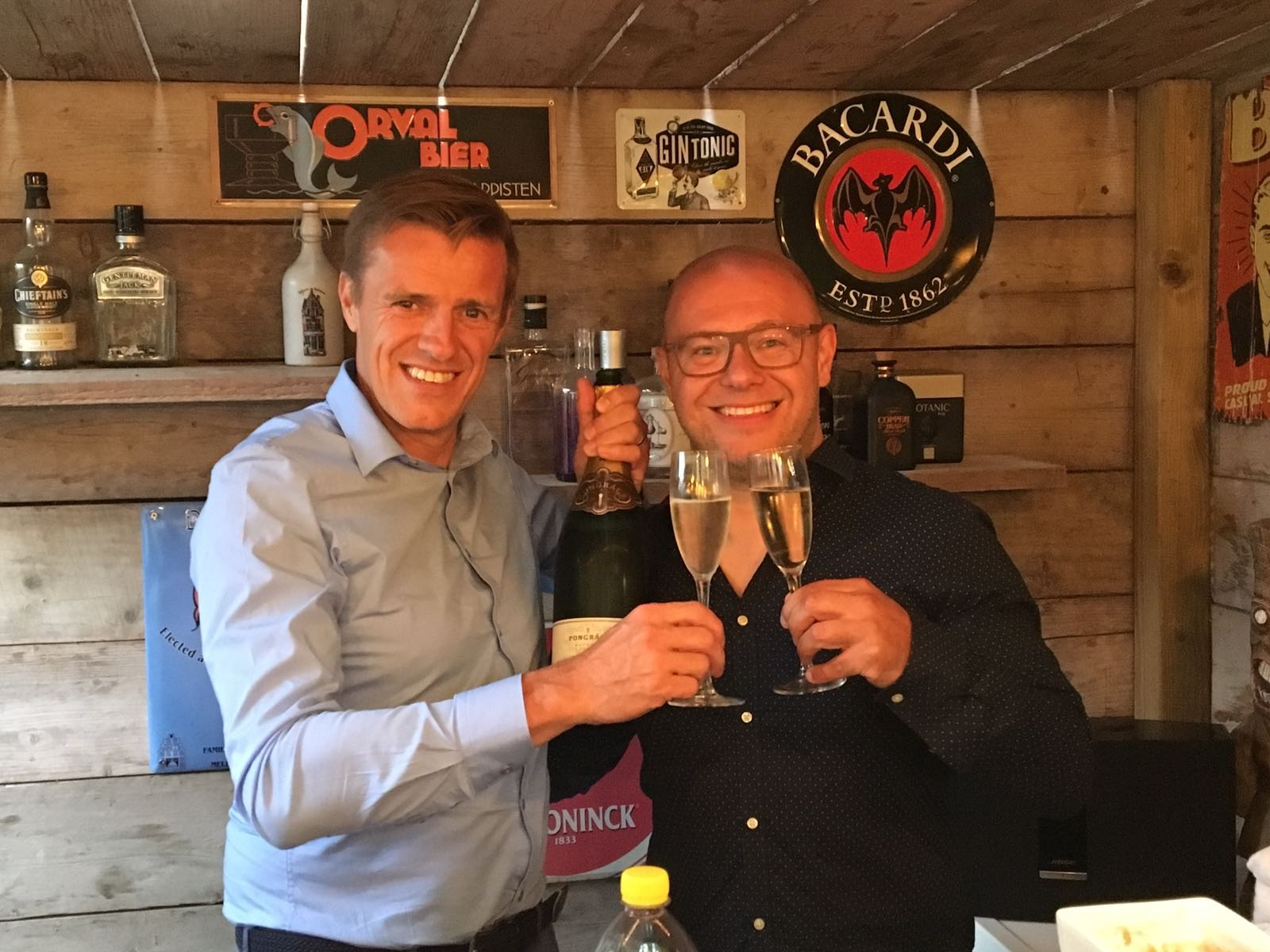 Dennis and Johan raising their glasses together